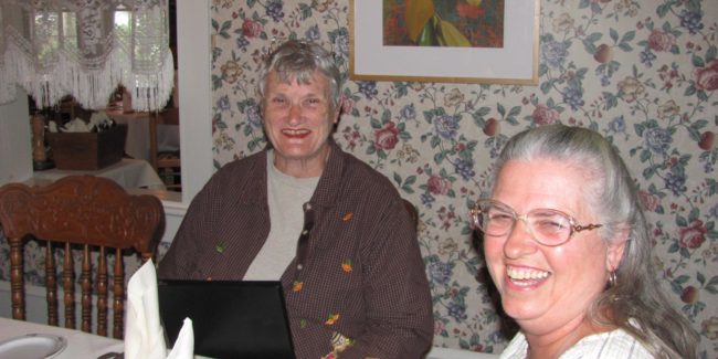 two women looking at menu and smiling