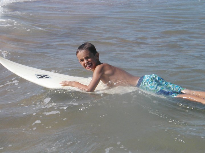young boy on surfboard