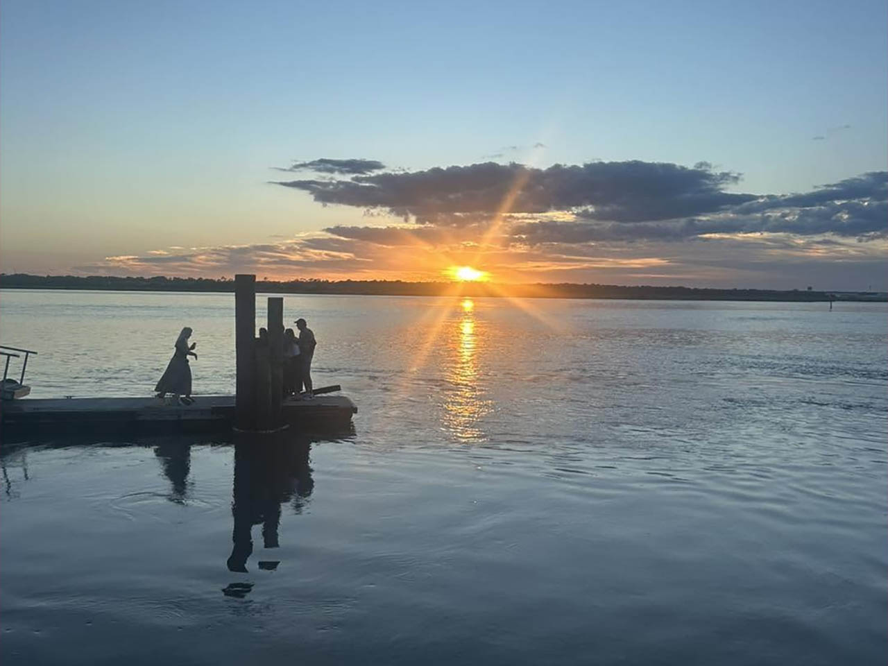 Sunrise over the Atlantic Ocean near North Beach Camp Resort in St. Augustine, Florida, with visitors enjoying the waterfront.